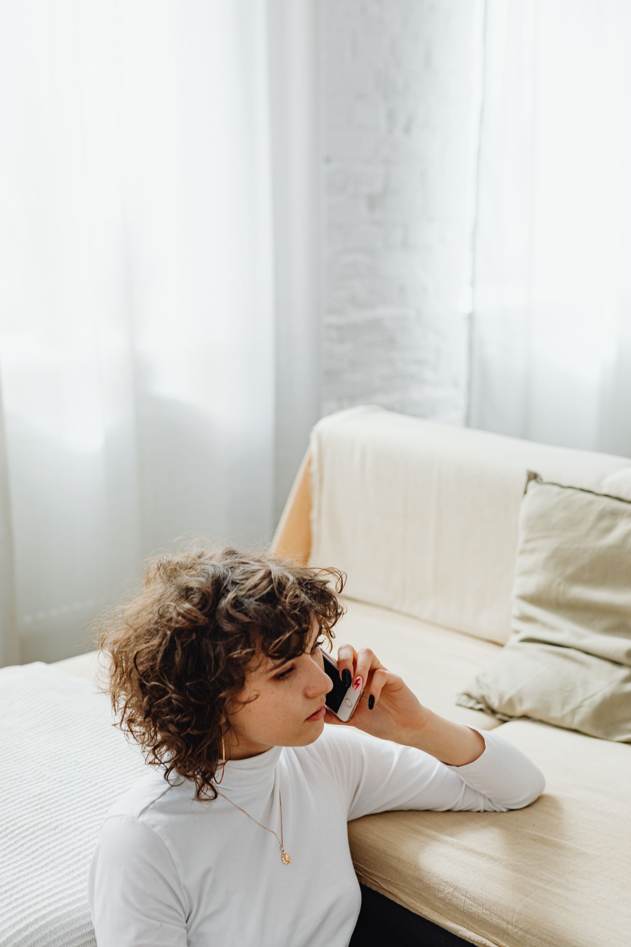 A young woman on her smartphone in a bright room